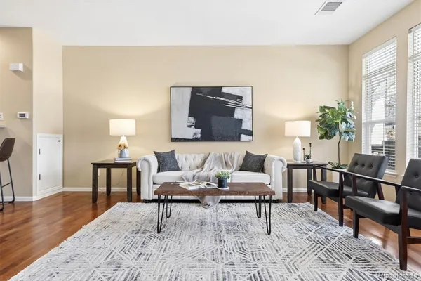 a living room with furniture and wooden floor