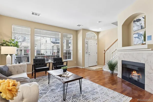a living room with furniture a window and a fireplace