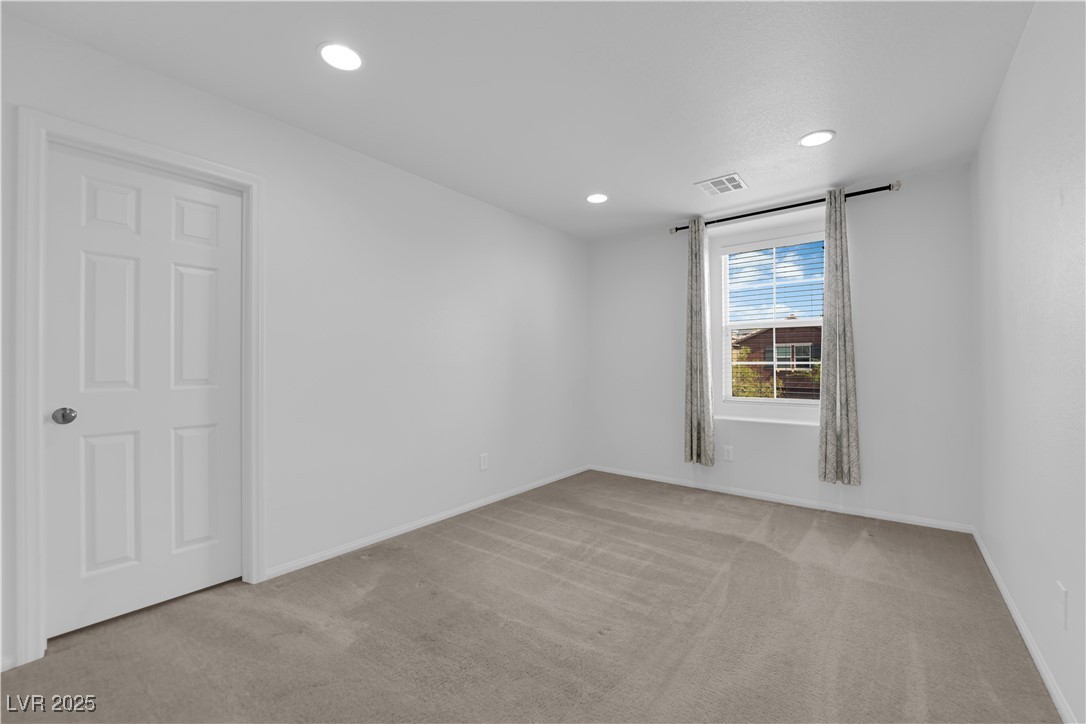 9205 Keystone Ridge Avenue Las Vegas, NV 89148 - Photo 23 of 40 Carpeted spare room featuring recessed lighting and baseboards