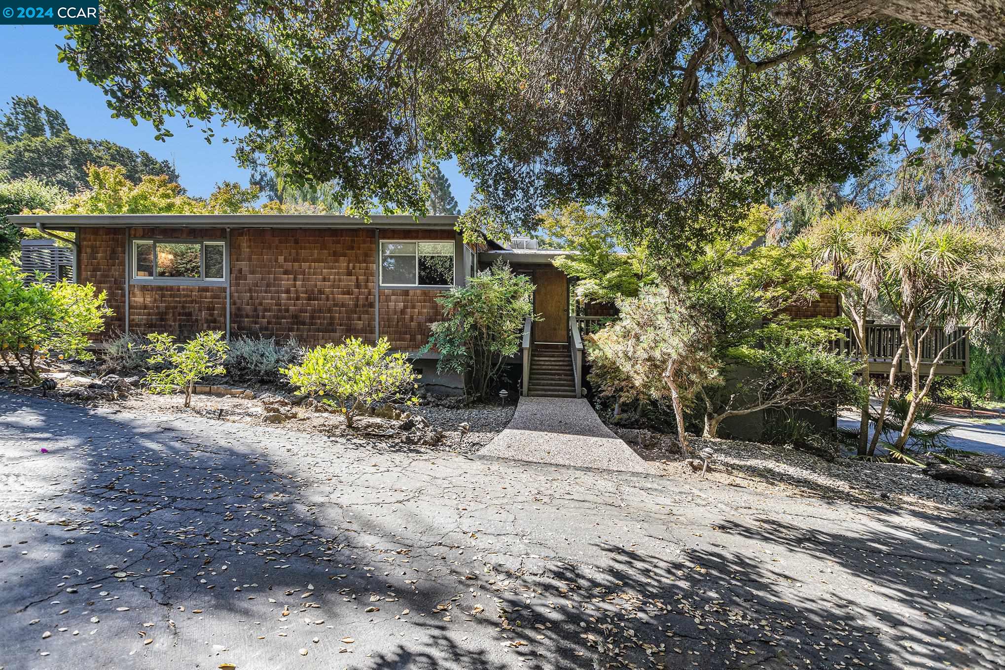 a front view of a house with garden