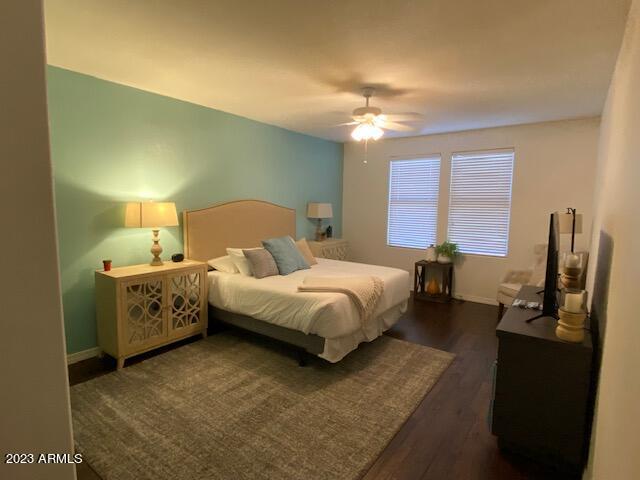 15221 North Clubgate Drive, Unit 2030 Scottsdale, AZ 85254 - Photo 12 of 26 a spacious bedroom with a bed and a chandelier