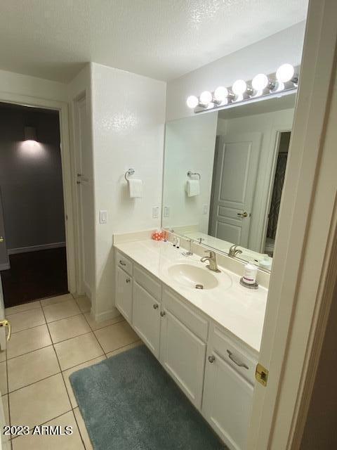 15221 North Clubgate Drive, Unit 2030 Scottsdale, AZ 85254 - Photo 16 of 26 a bathroom with a sink a mirror and a shower