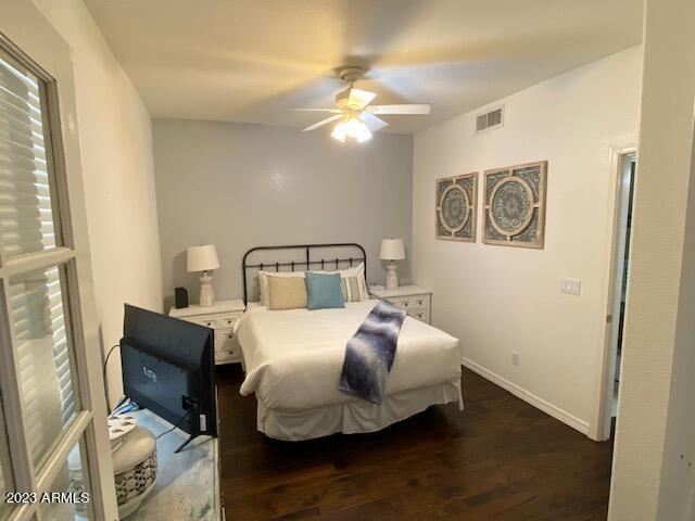 15221 North Clubgate Drive, Unit 2030 Scottsdale, AZ 85254 - Photo 18 of 26 a bedroom with a bed and lamp