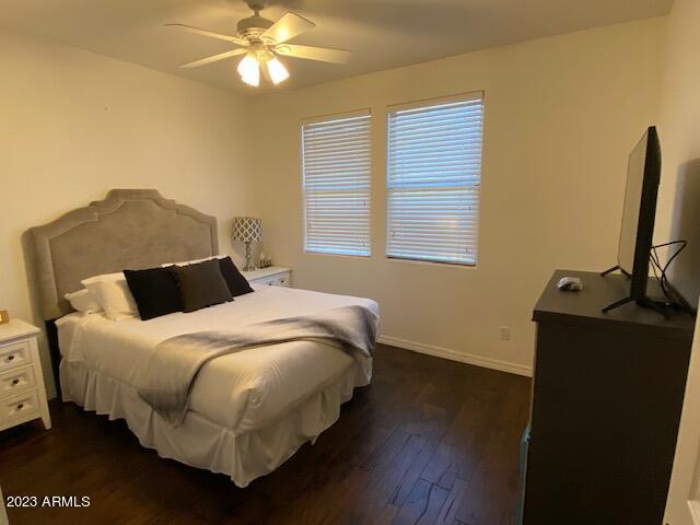 15221 North Clubgate Drive, Unit 2030 Scottsdale, AZ 85254 - Photo 21 of 26 a bedroom with a bed and wooden floor