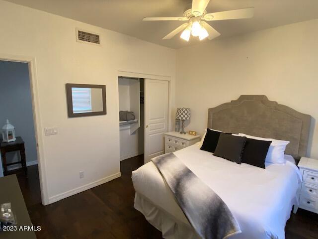 15221 North Clubgate Drive, Unit 2030 Scottsdale, AZ 85254 - Photo 22 of 26 a bedroom with a bed and a chandelier