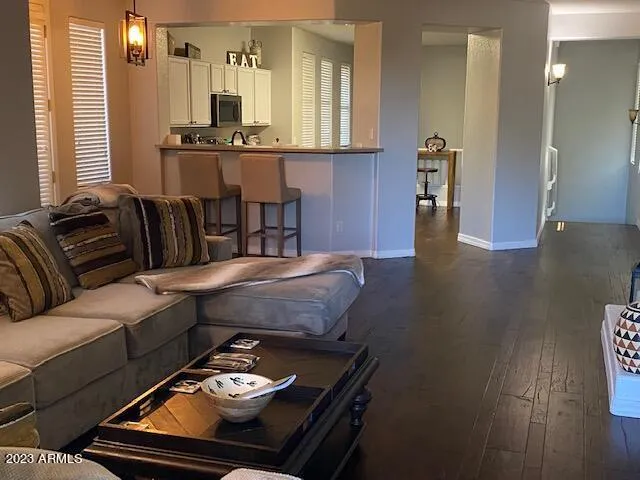 a living room with furniture and a chandelier