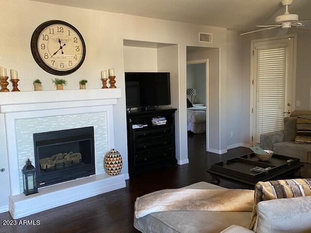 15221 North Clubgate Drive, Unit 2030 Scottsdale, AZ 85254 - Photo 9 of 26 a living room with furniture a clock and a fireplace