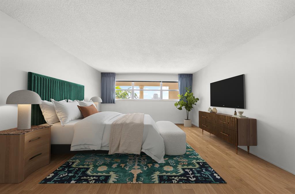 1710 South Ocean Lane, Unit 404 Fort Lauderdale, FL 33316 - Photo 14 of 33 a bedroom with a bed and a flat screen tv