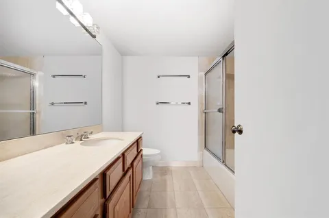 a bathroom with a sink a mirror and a shower