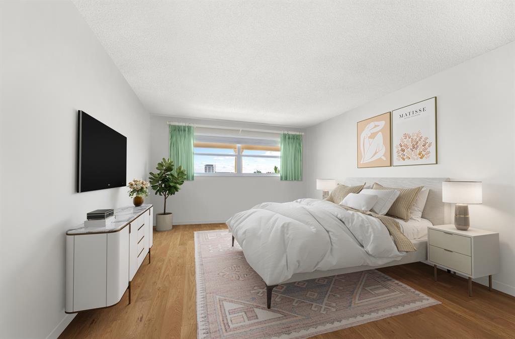 1710 South Ocean Lane, Unit 404 Fort Lauderdale, FL 33316 - Photo 16 of 33 a spacious bedroom with a bed and a flat screen tv