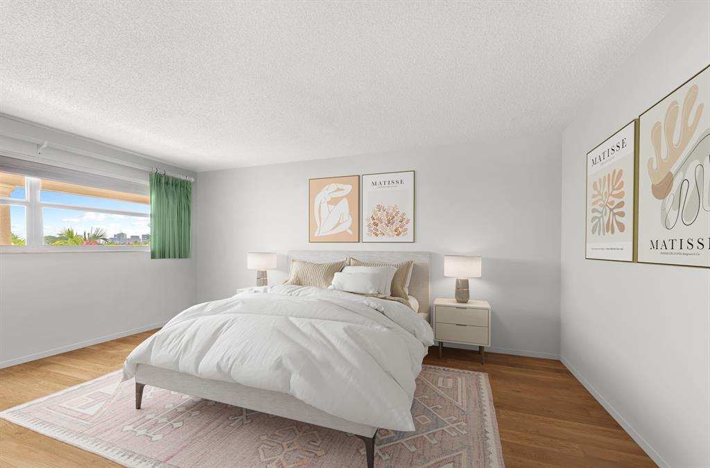 1710 South Ocean Lane, Unit 404 Fort Lauderdale, FL 33316 - Photo 18 of 33 a bedroom with a bed and painting on the wall