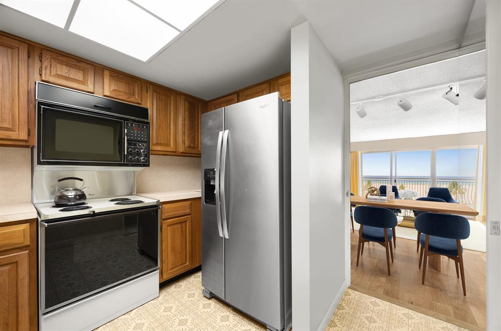 1710 South Ocean Lane, Unit 404 Fort Lauderdale, FL 33316 - Photo 20 of 33 a kitchen with stainless steel appliances a stove a sink and a microwave