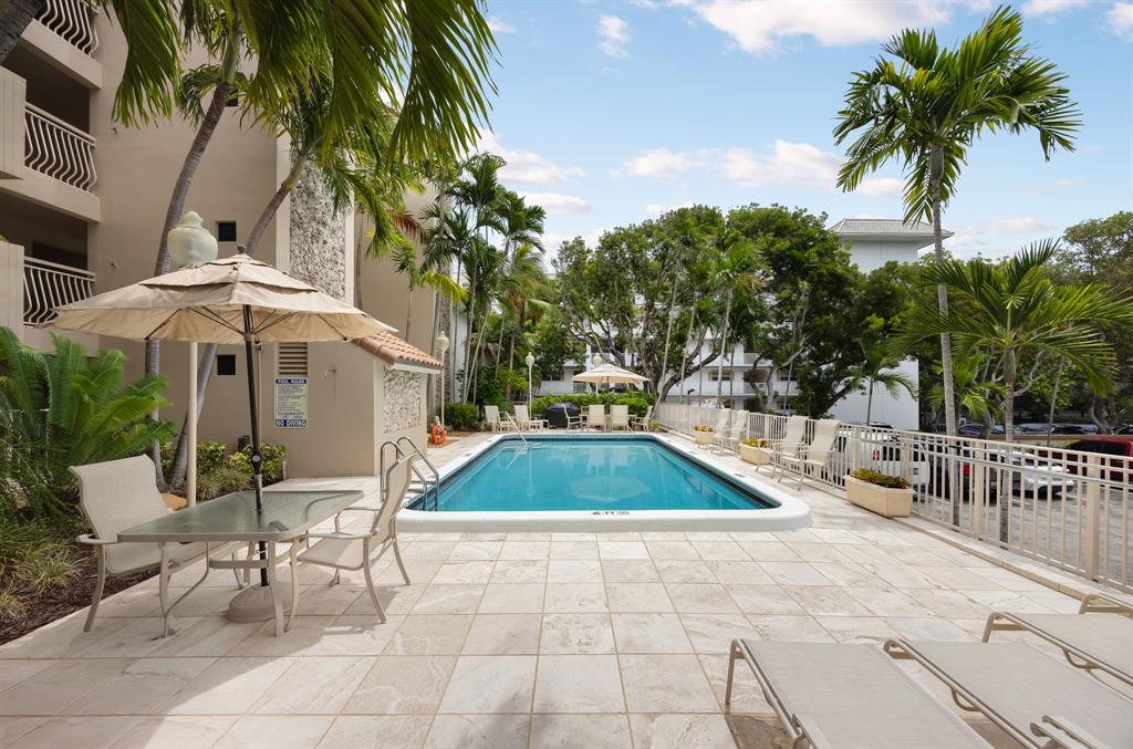1710 South Ocean Lane, Unit 404 Fort Lauderdale, FL 33316 - Photo 22 of 33 a lawn chairs sitting in a backyard