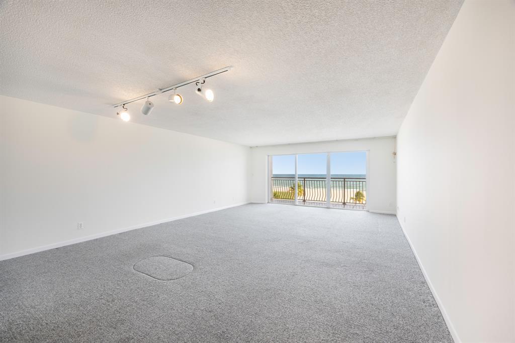 1710 South Ocean Lane, Unit 404 Fort Lauderdale, FL 33316 - Photo 23 of 33 an empty room with a window and a ceiling fan