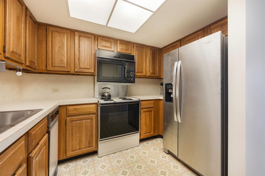 1710 South Ocean Lane, Unit 404 Fort Lauderdale, FL 33316 - Photo 27 of 33 a kitchen with stainless steel appliances granite countertop a refrigerator stove and microwave