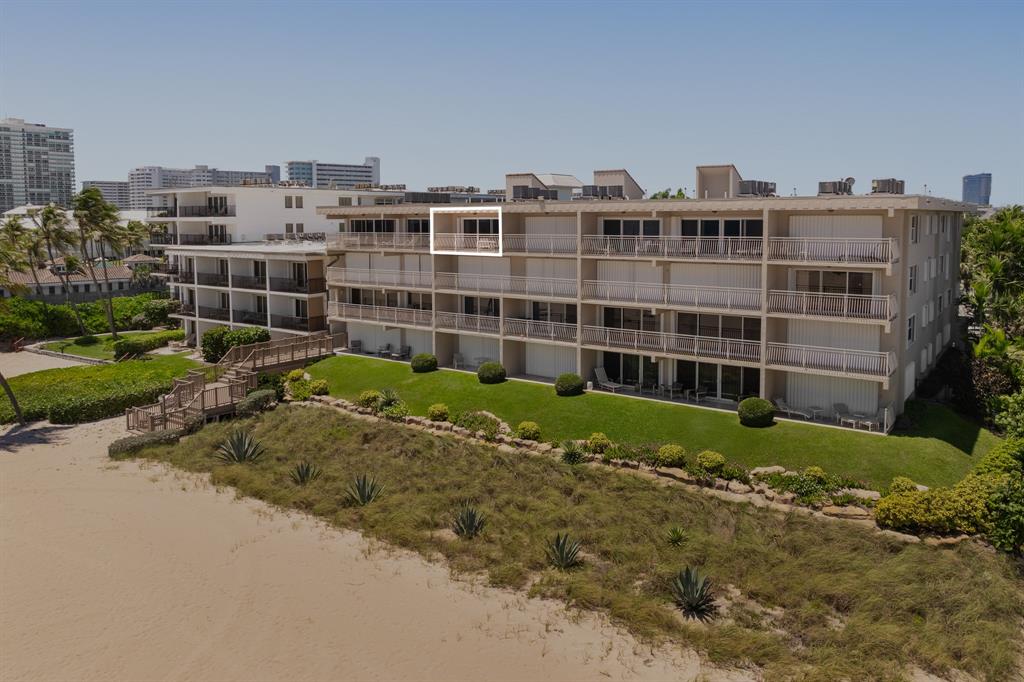 1710 South Ocean Lane, Unit 404 Fort Lauderdale, FL 33316 - Photo 4 of 33 a view of a building with a garden and trees