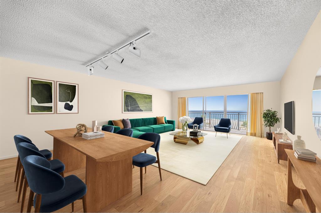 1710 South Ocean Lane, Unit 404 Fort Lauderdale, FL 33316 - Photo 6 of 33 a living room with furniture a flat screen tv and a table