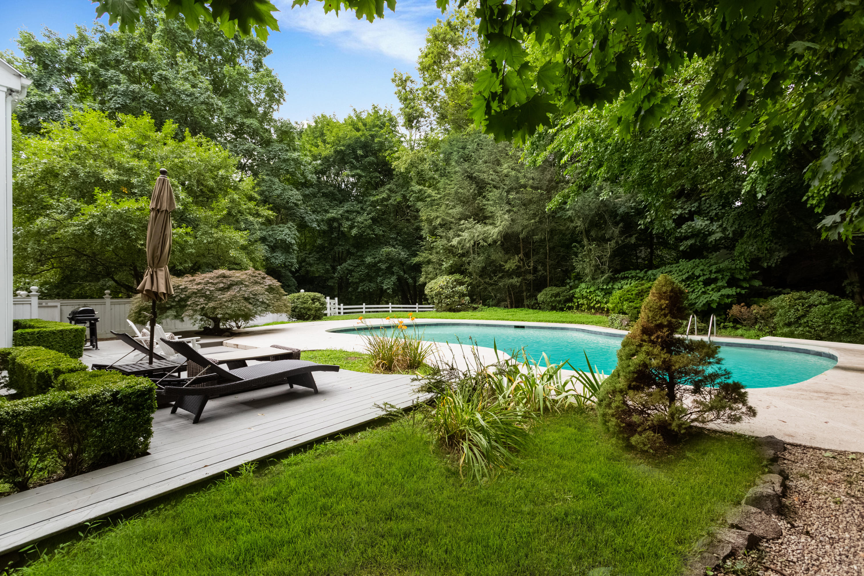 36 Locust Hill Road Darien, CT 06820 - Photo 1 of 40 a view of a swimming pool with a patio