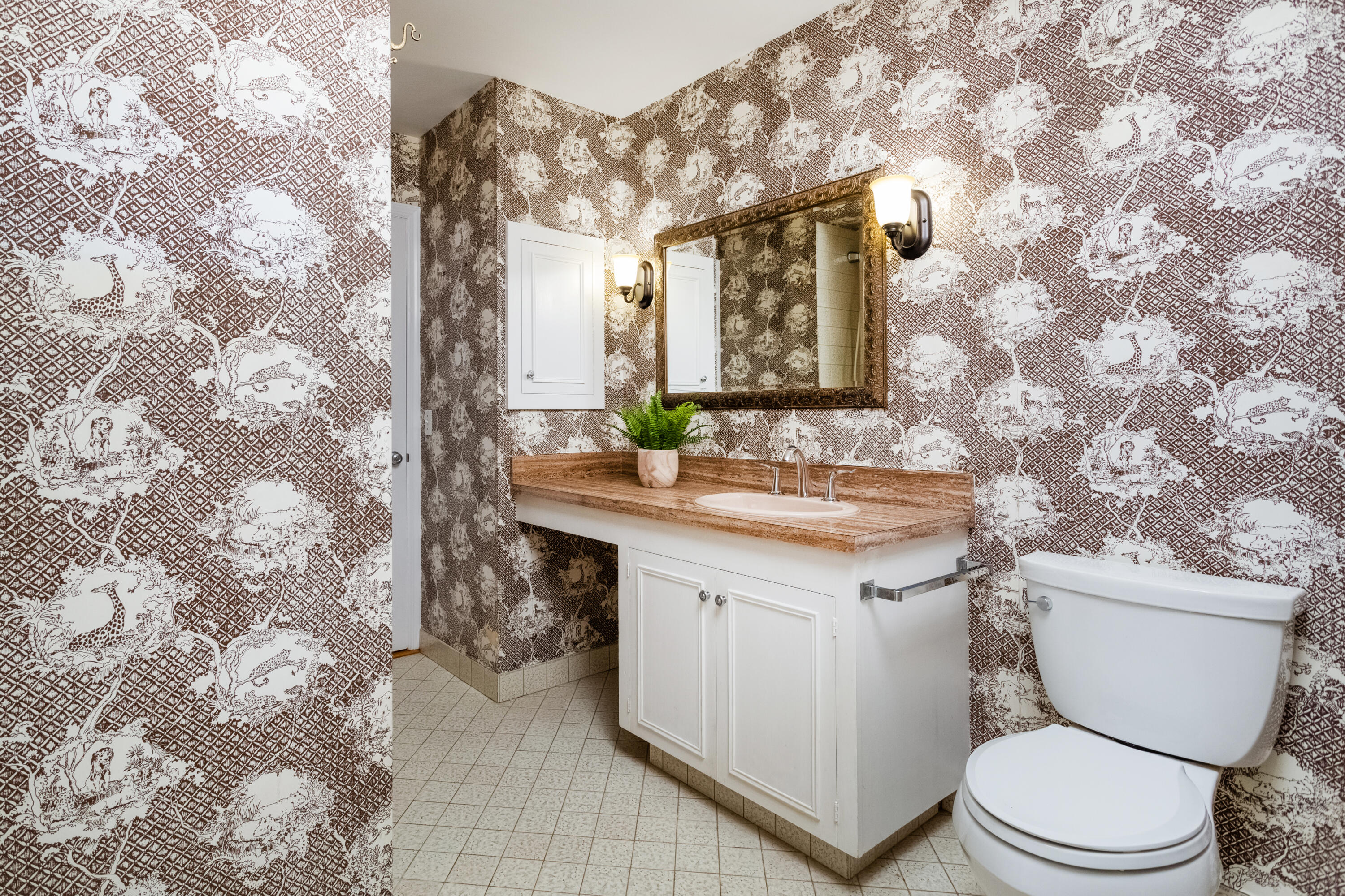 36 Locust Hill Road Darien, CT 06820 - Photo 17 of 40 a bathroom with a granite countertop sink a toilet and a mirror