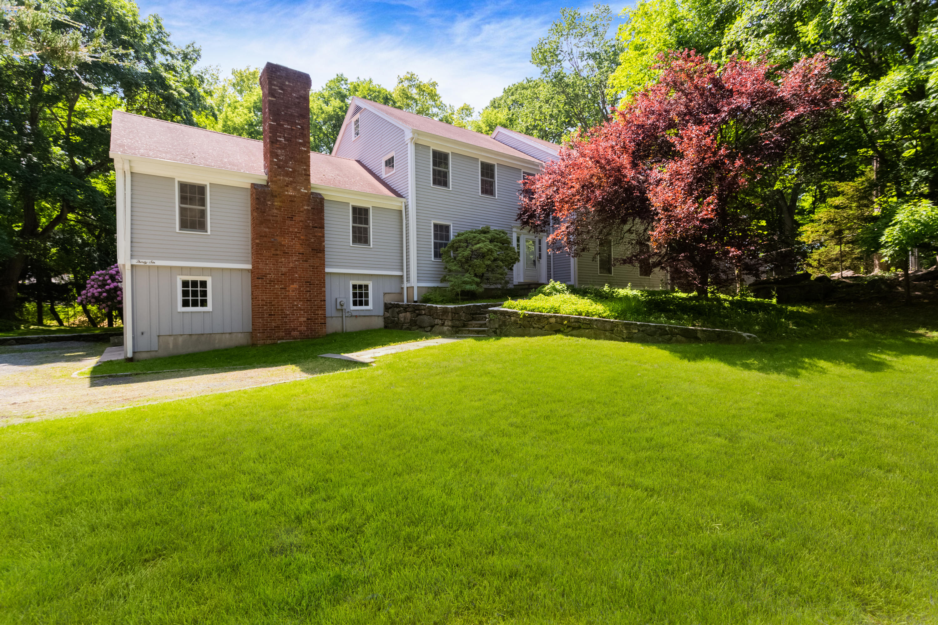 36 Locust Hill Road Darien, CT 06820 - Photo 3 of 40 a view of a house with a big yard and large trees