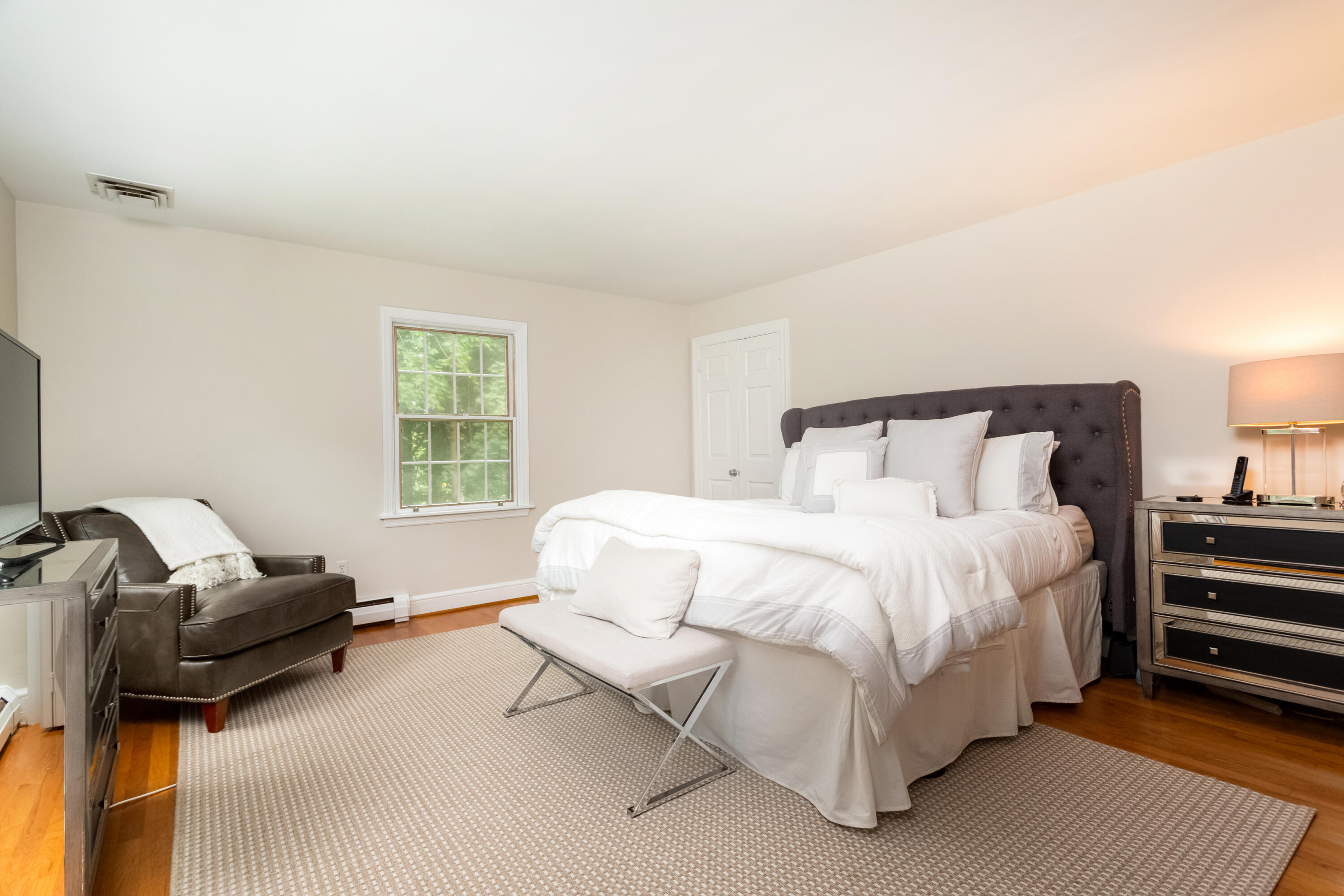 36 Locust Hill Road Darien, CT 06820 - Photo 21 of 40 a bedroom with a bed couch and a window