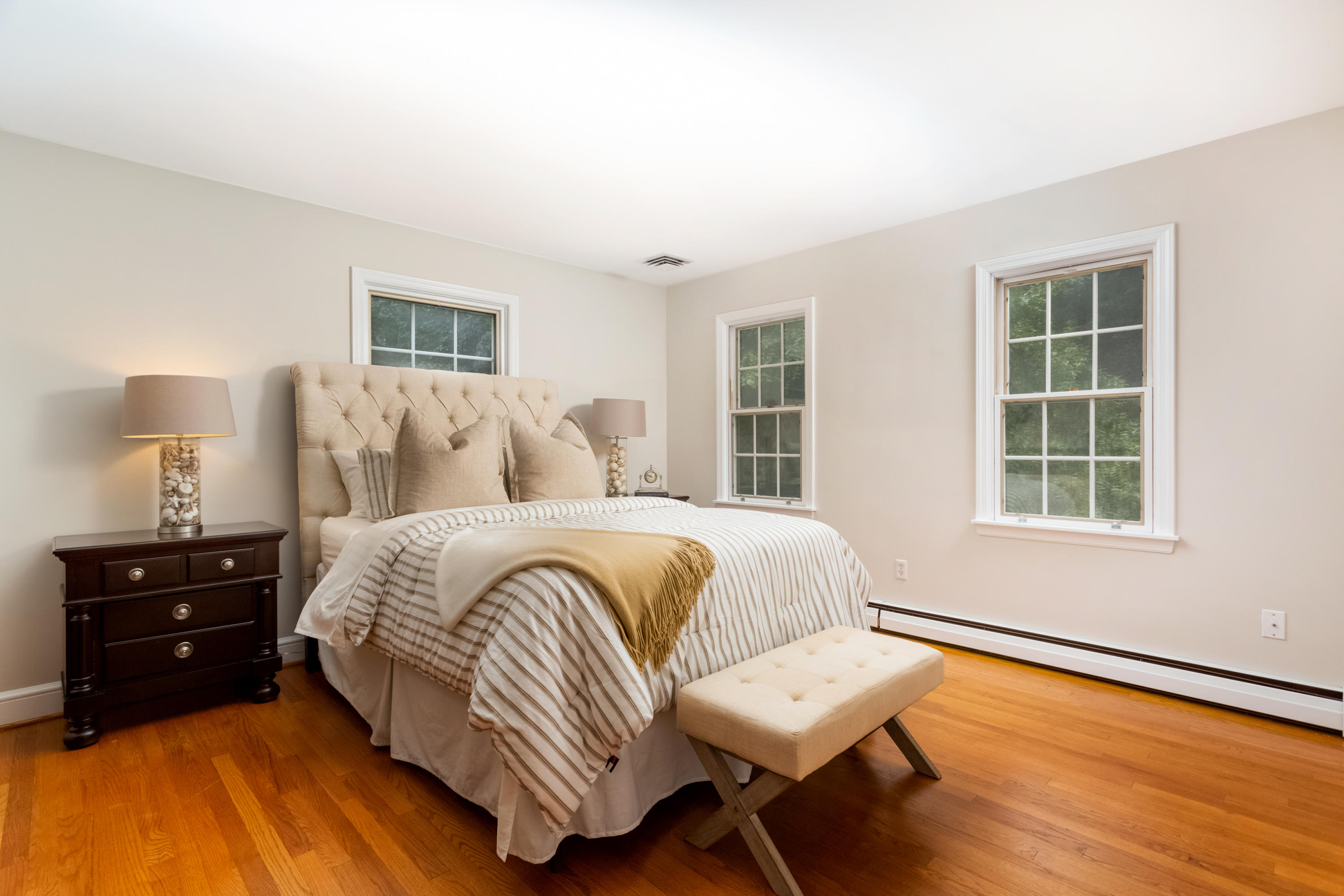 36 Locust Hill Road Darien, CT 06820 - Photo 27 of 40 a bedroom with a bed and a dresser with wooden floor