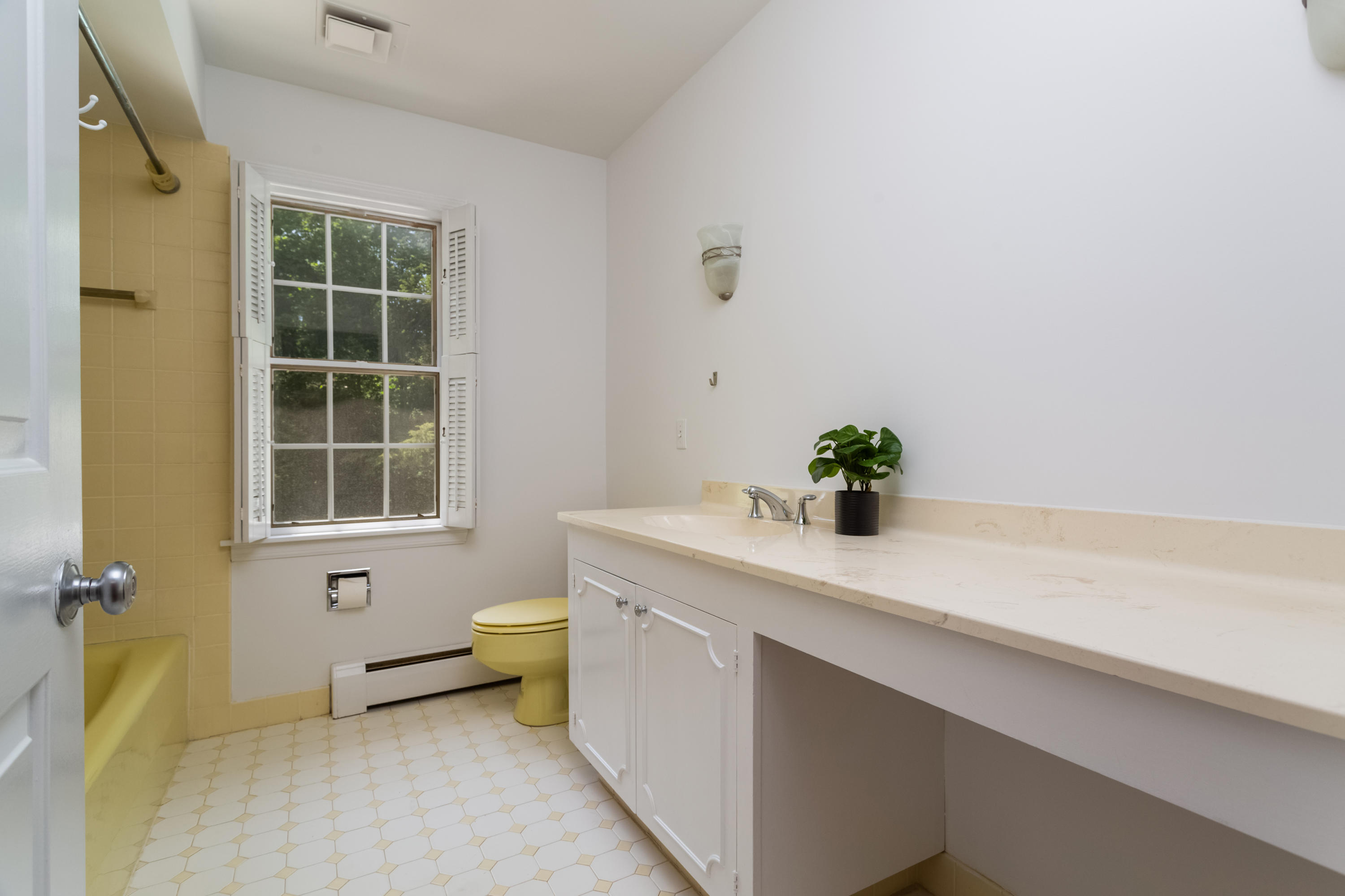 36 Locust Hill Road Darien, CT 06820 - Photo 30 of 40 a bathroom with a sink a toilet and a window