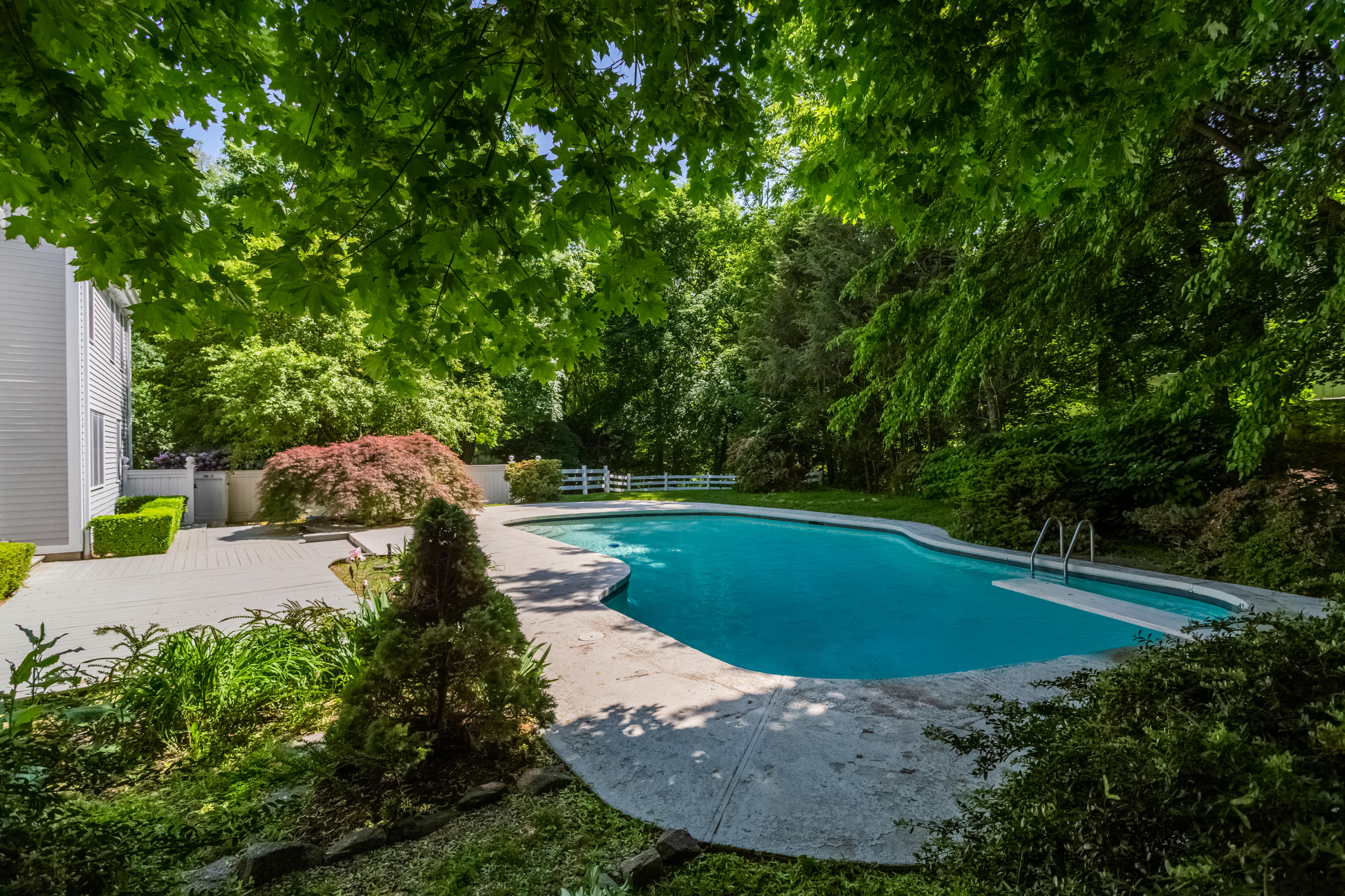 36 Locust Hill Road Darien, CT 06820 - Photo 32 of 40 a view of a swimming pool with an outdoor space and seating area