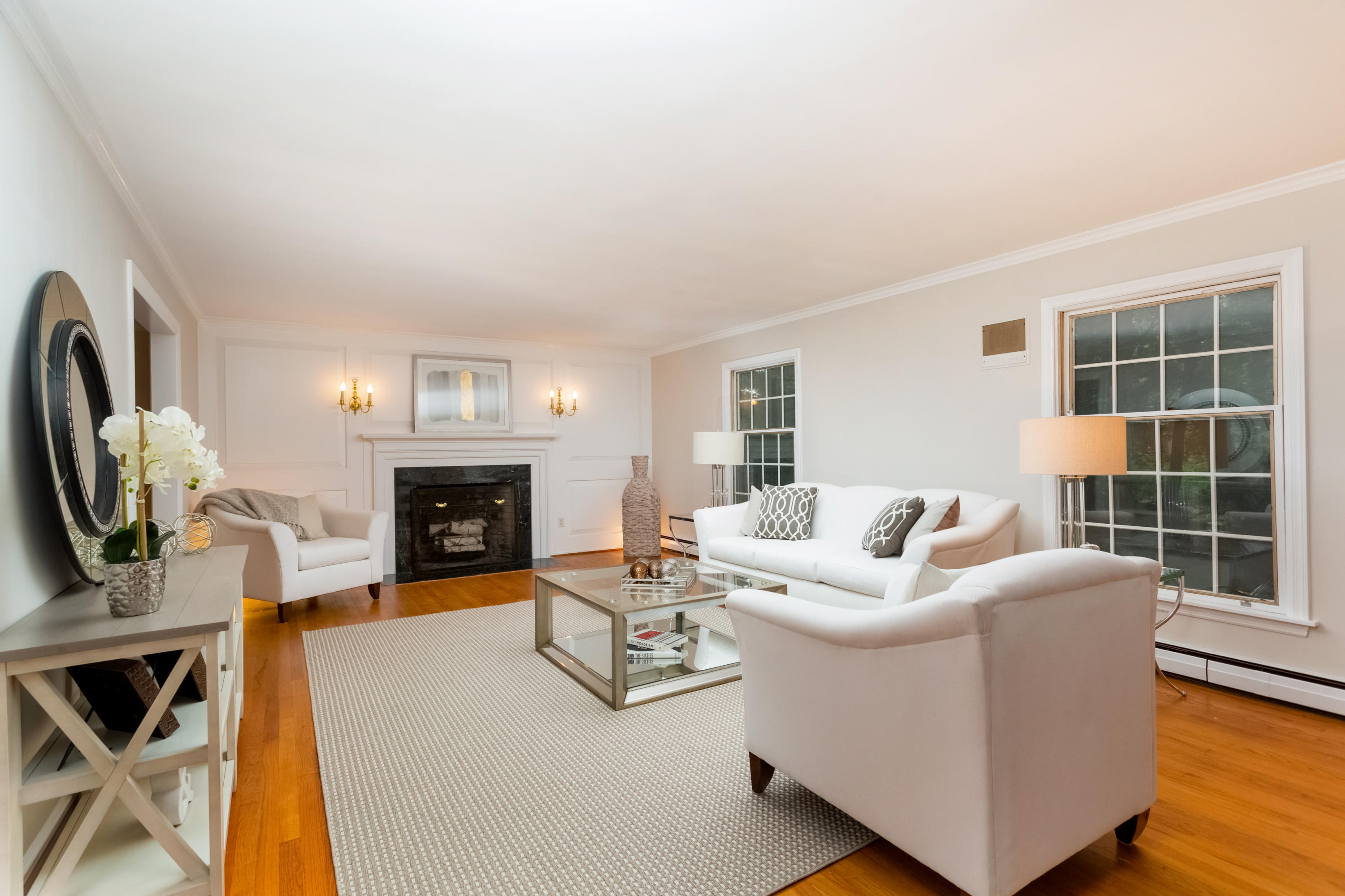 36 Locust Hill Road Darien, CT 06820 - Photo 6 of 40 a living room with furniture a fireplace and a floor to ceiling window