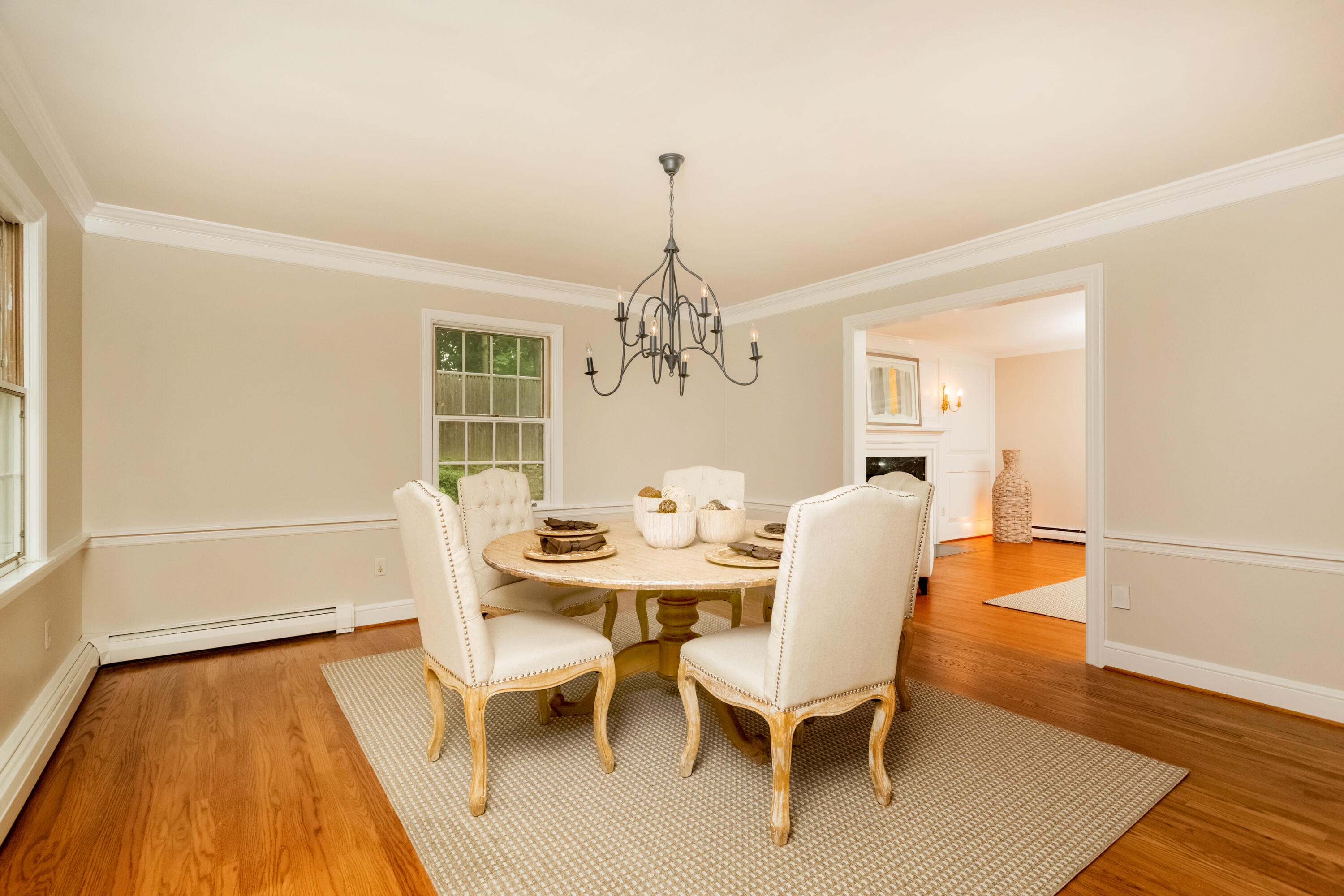 36 Locust Hill Road Darien, CT 06820 - Photo 9 of 40 a dining room with wooden floor and chandelier