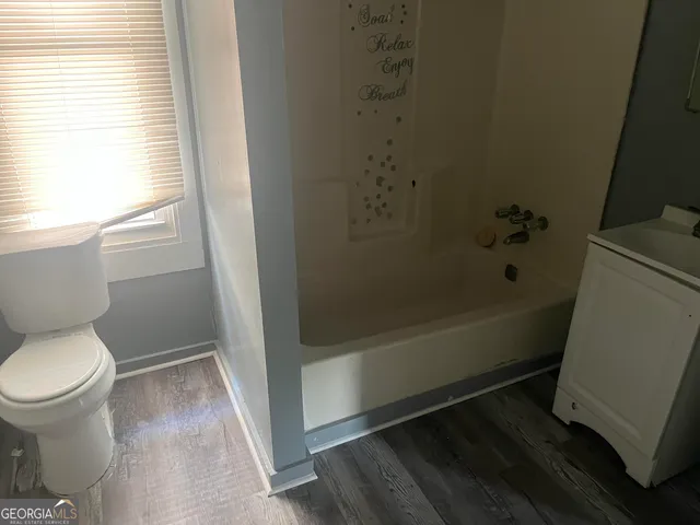 a bathroom with a toilet and a bathtub