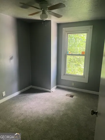 an empty room with a empty space and windows