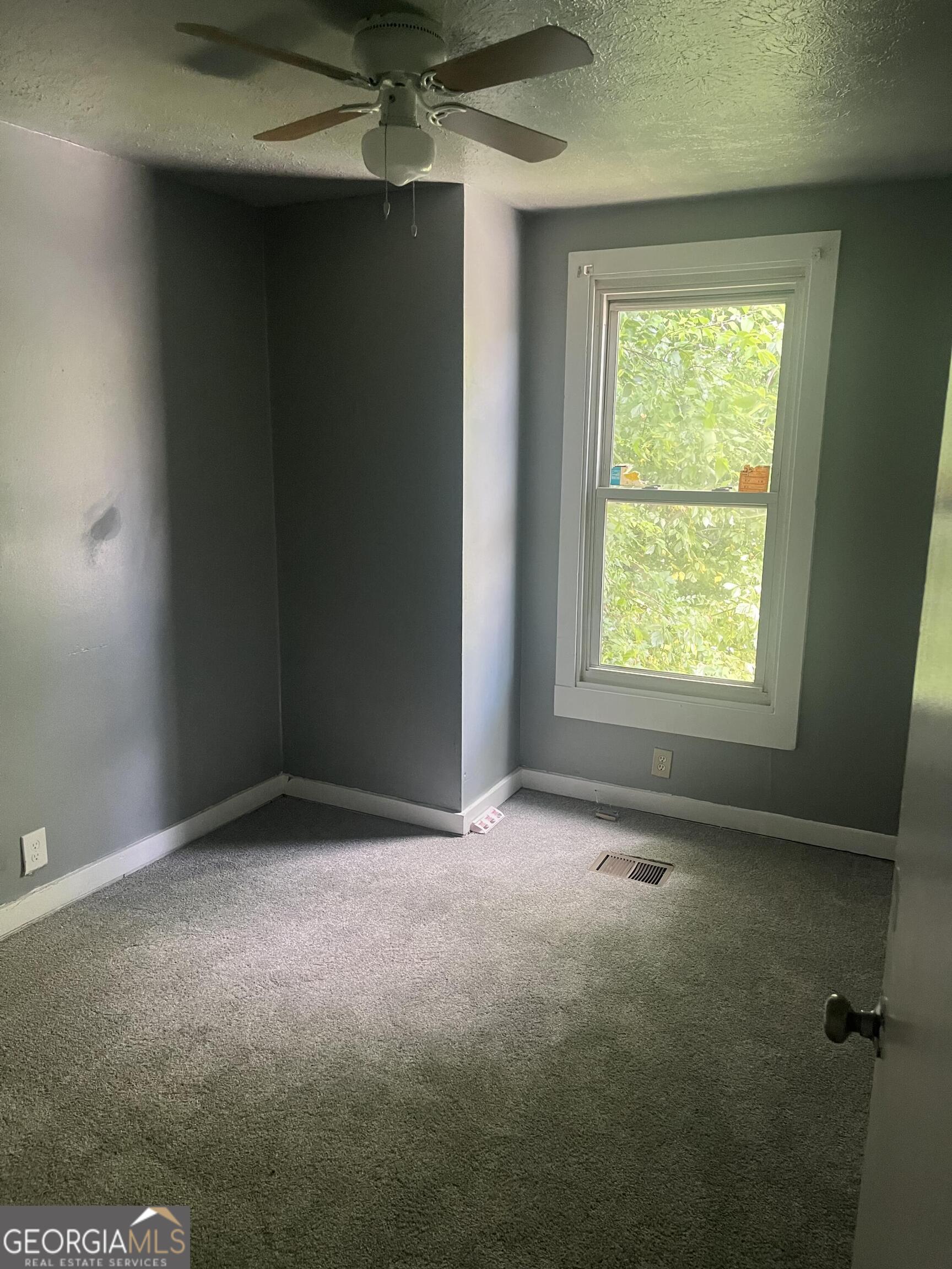 821 Beckwith Street Southwest Atlanta, GA 30314 - Photo 5 of 16 an empty room with a empty space and windows