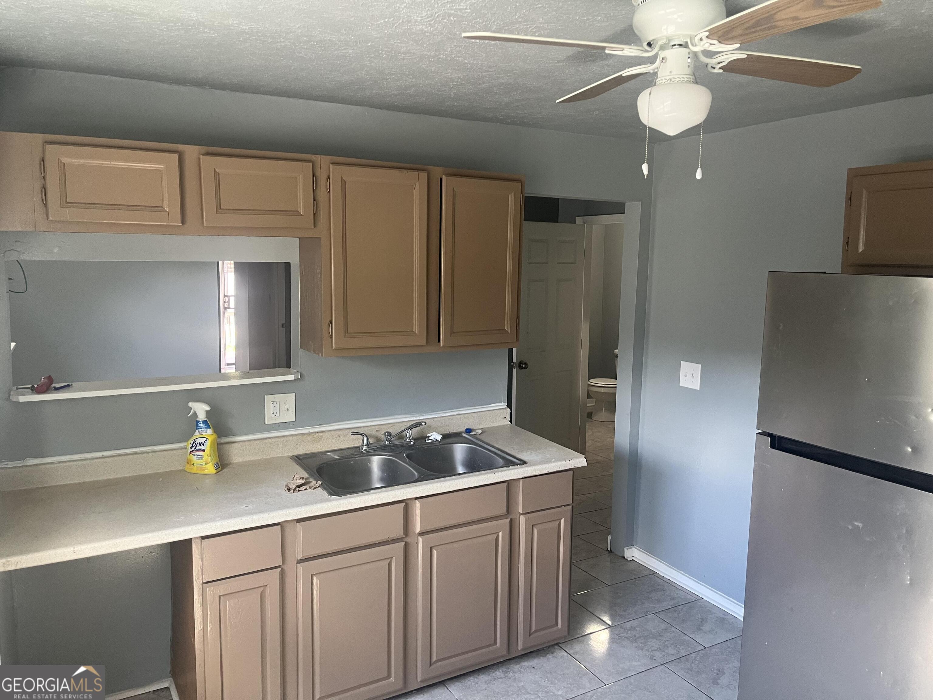 821 Beckwith Street Southwest Atlanta, GA 30314 - Photo 8 of 16 a kitchen with stainless steel appliances granite countertop a sink a stove and a refrigerator