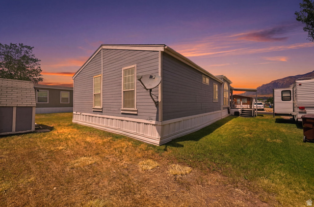 2491 Highway 89, Unit 614 Pleasant View, UT 84404 - Photo 2 of 27 Light gray siding exterior with white trim and white skirting