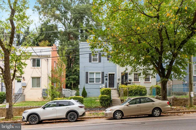 a car parked in front of a white house