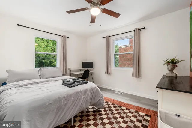 a bedroom with a bed and painting on the wall