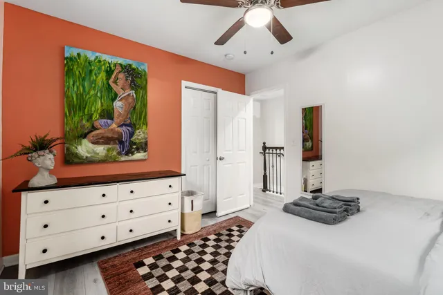 a bedroom with a bed and a window with a chandelier