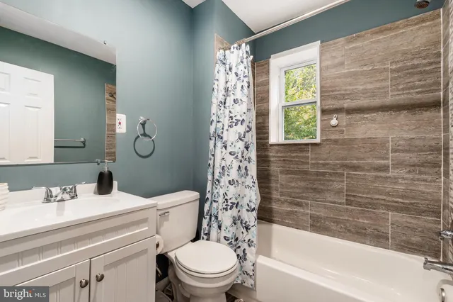 a living room with furniture a window and a table