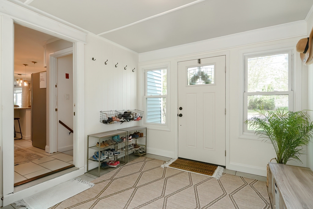 57 Cove Street Riverside, RI 02915 - Photo 8 of 42 a view of an entryway with wooden floor and a livingroom