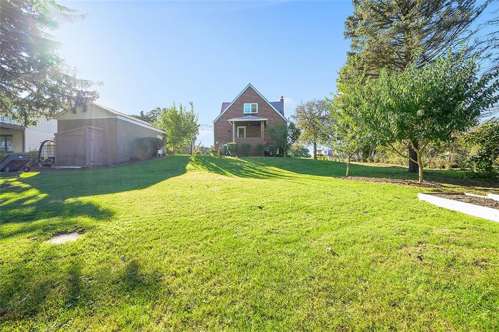 2016 Ridge Rd Extension Ambridge, PA 15003 - Photo 3 of 25 a house with a yard and a large tree