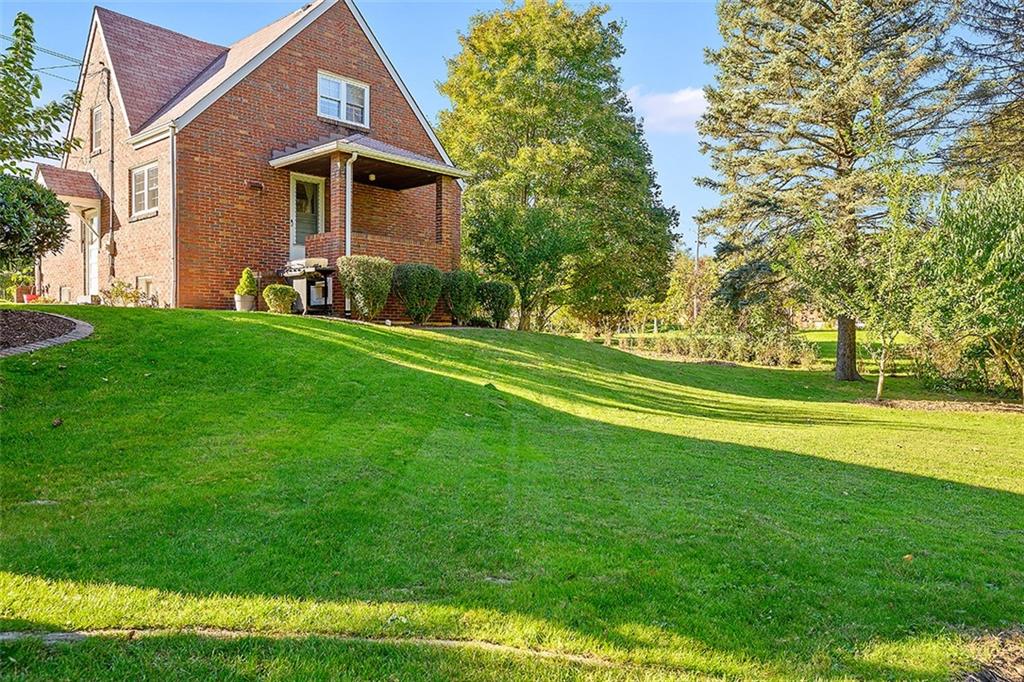 2016 Ridge Rd Extension Ambridge, PA 15003 - Photo 4 of 25 a front view of a house with a yard and trees