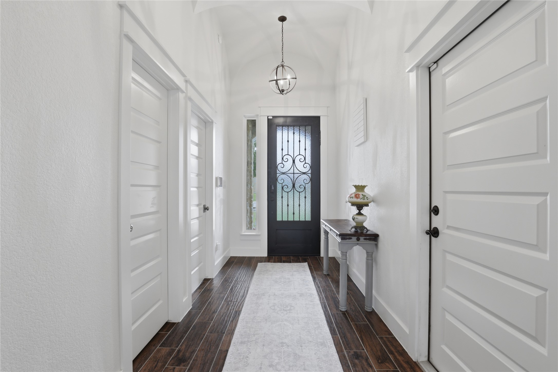 133 Greg Lane Jarrell, TX 76537 - Photo 5 of 24 Entryway featuring a dark wood-finish door with decorative wrought iron detailing and clear glass inserts