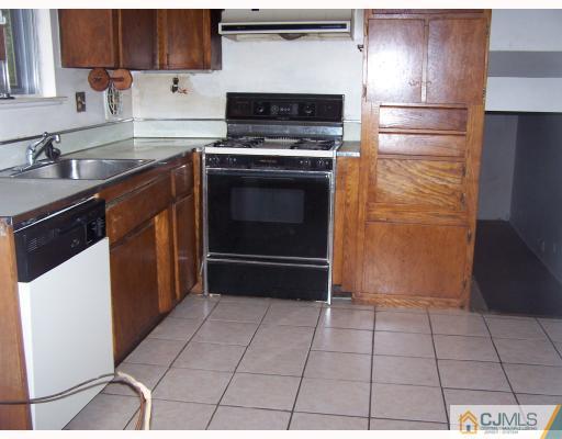 26 Lexington Road Somerset, NJ 08873 - Photo 9 of 10 a kitchen with granite countertop a stove a sink and a refrigerator