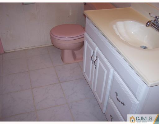 26 Lexington Road Somerset, NJ 08873 - Photo 10 of 10 a bathroom with a sink a toilet and shower