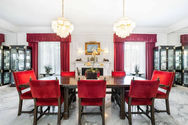 a view of a dining room with furniture and a chandelier