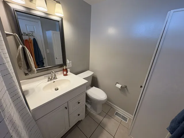 a bathroom with a sink toilet and mirror