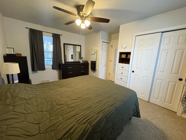 a bedroom with a bed and a flat tv screen