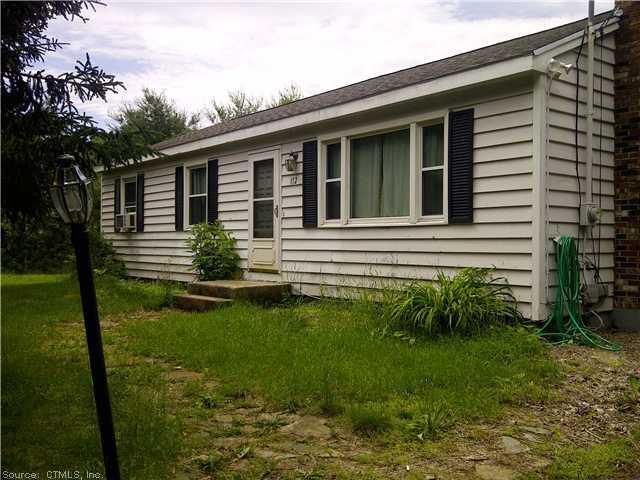 112 Plains Road Windham, CT 06280 - Photo 1 of 1 a front view of a house with garden