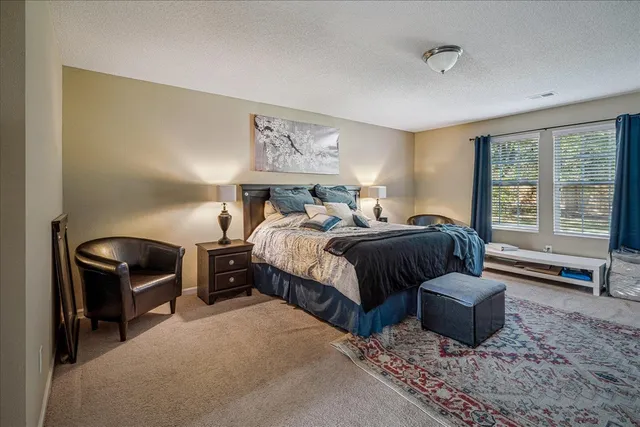 a bedroom with a bed and a couch